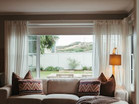 Views of cliff track, comfortable sofa, reading material