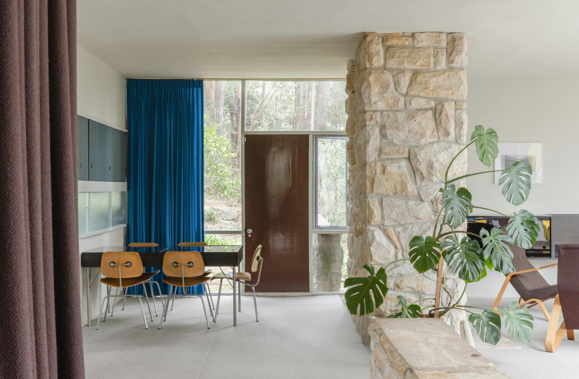 Midcentury living area with stone pillar