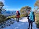 Hiking on a snow covered trail on a bluebird day enjoying views of the surrounding mountains
