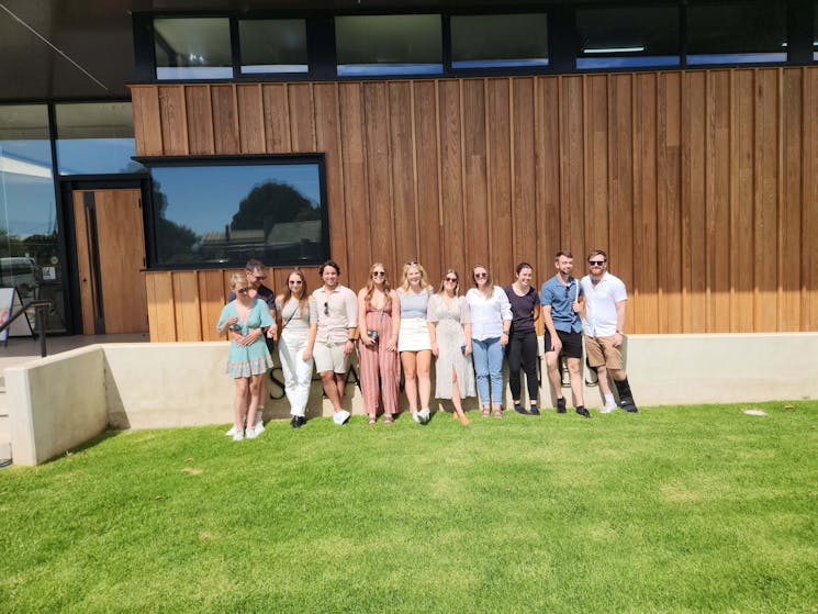Group of friends posing for photo outside Shaw Wines on a Merry Heart CBR Great Tour