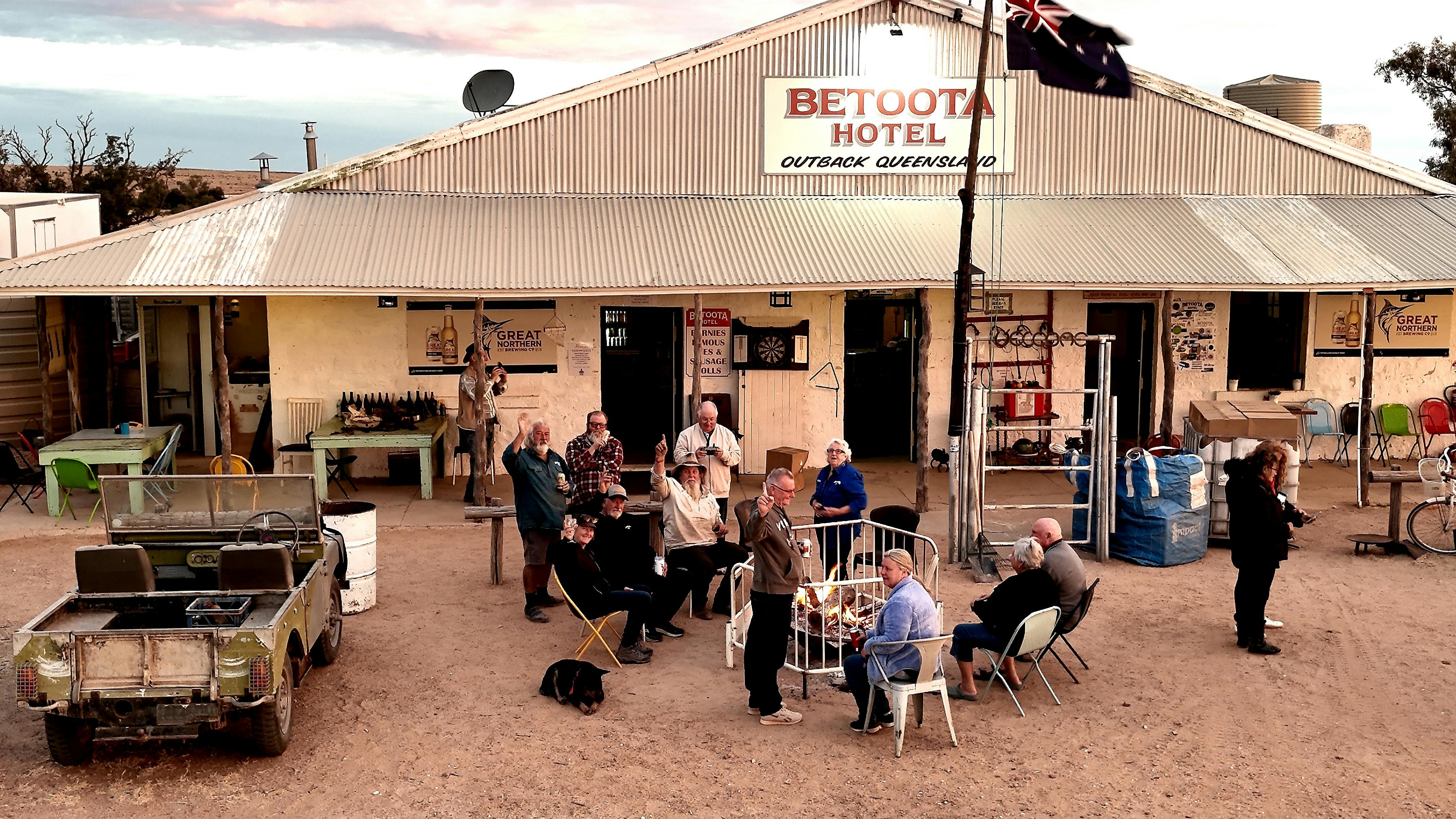 Travellers sharing stories around a fire at the Betoota Hotel in Outback Queensland.