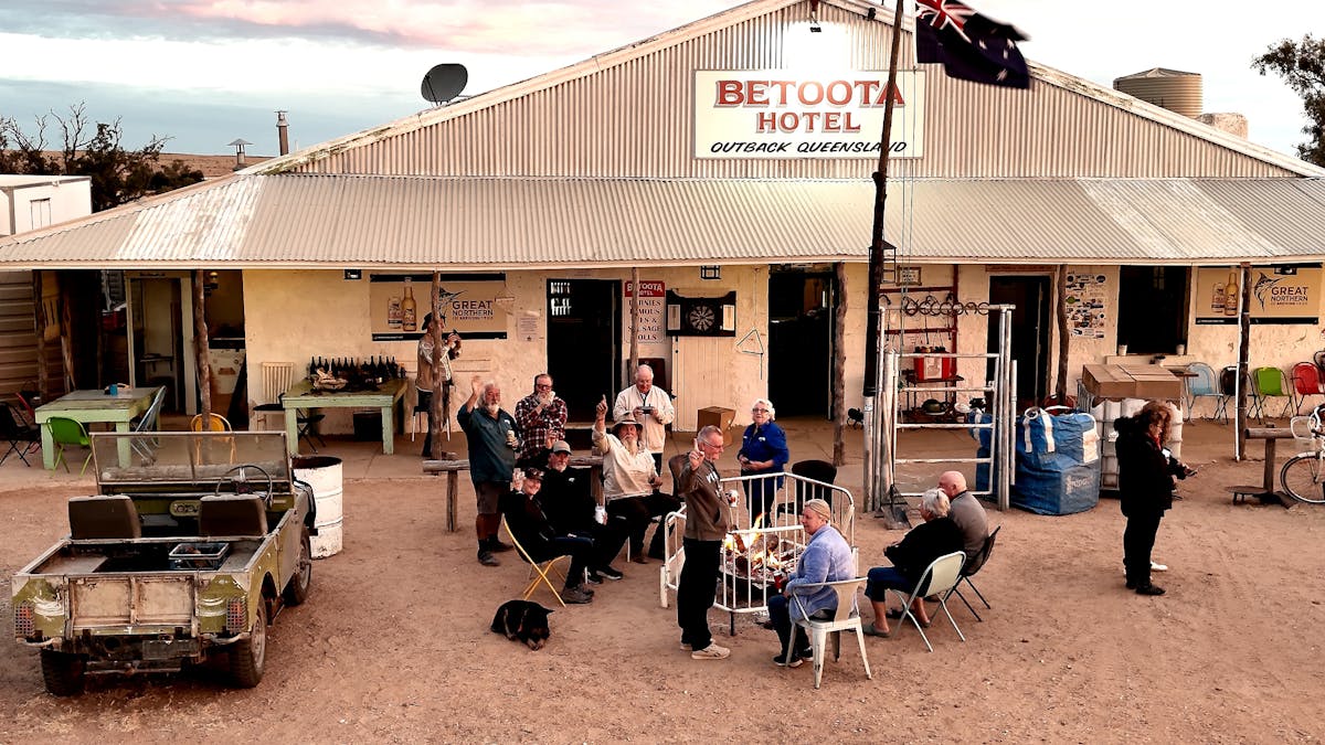 Travellers sharing stories around a fire at the Betoota Hotel in Outback Queensland. Travellers sharing stories around a fire at the Betoota Hotel in Outback Queensland.