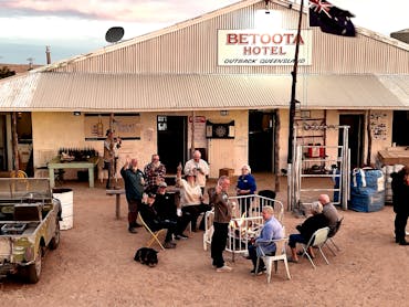 Travellers sharing stories around a fire at the Betoota Hotel in Outback Queensland.