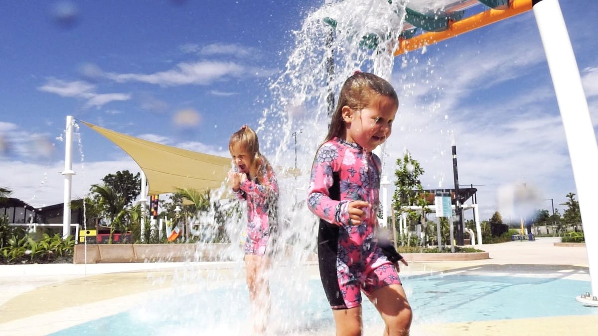 Girls playing at The Mill Water Park Petrie under Water Buckets