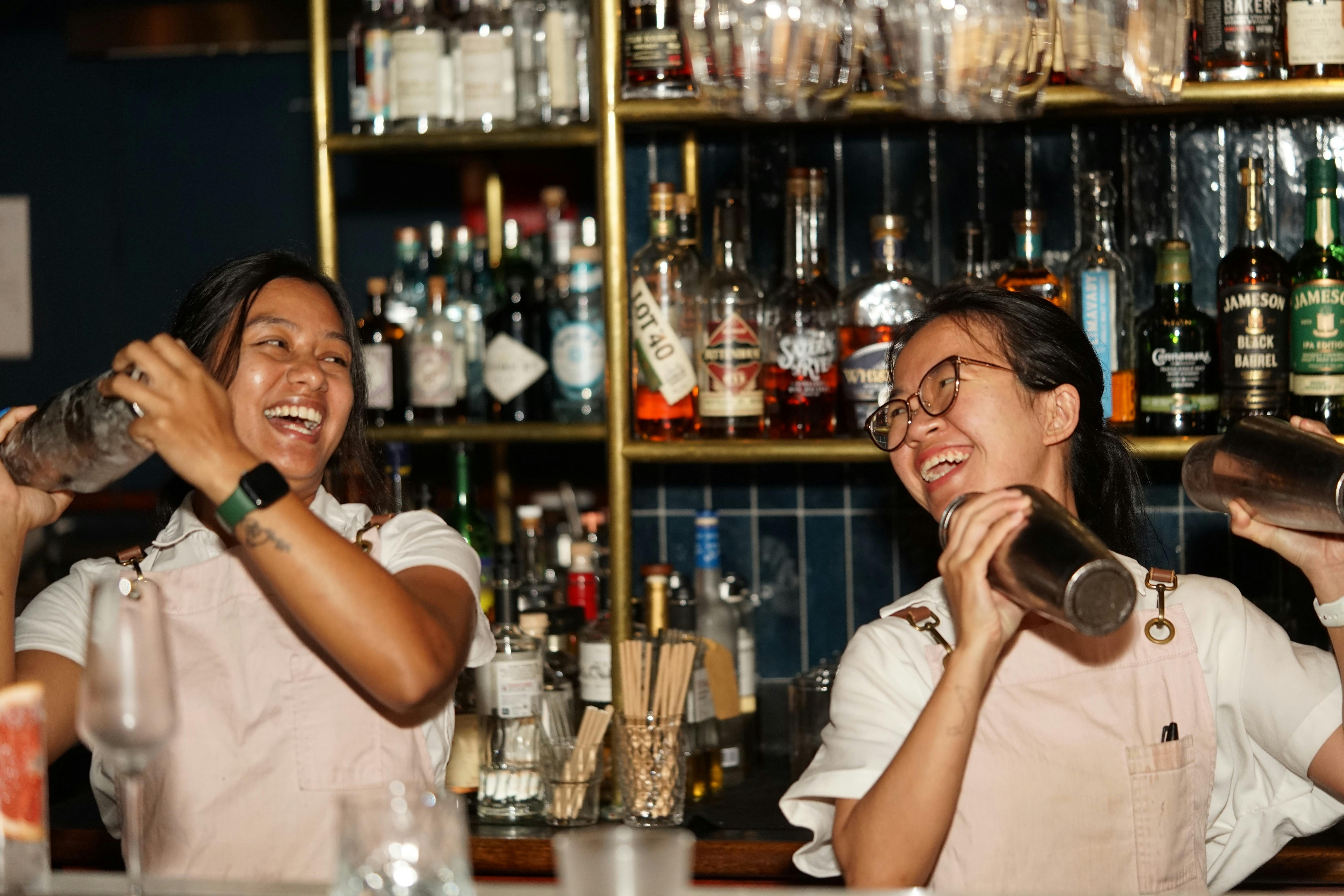Bartenders shaking up some drinks
