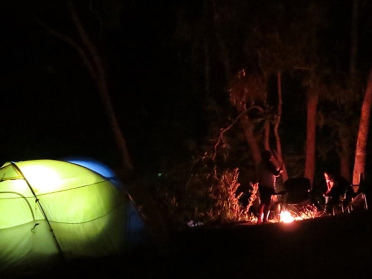 People enjoy dinner around a campfire at Abercrombie Caves campground. Photo: Stephen Babka/DPIE