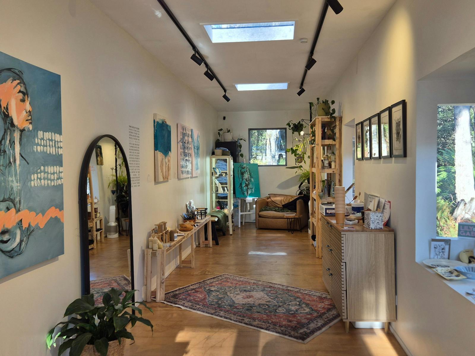 The inside of Blue Tree Gallery, A renovated shipping container with artwork over the walls