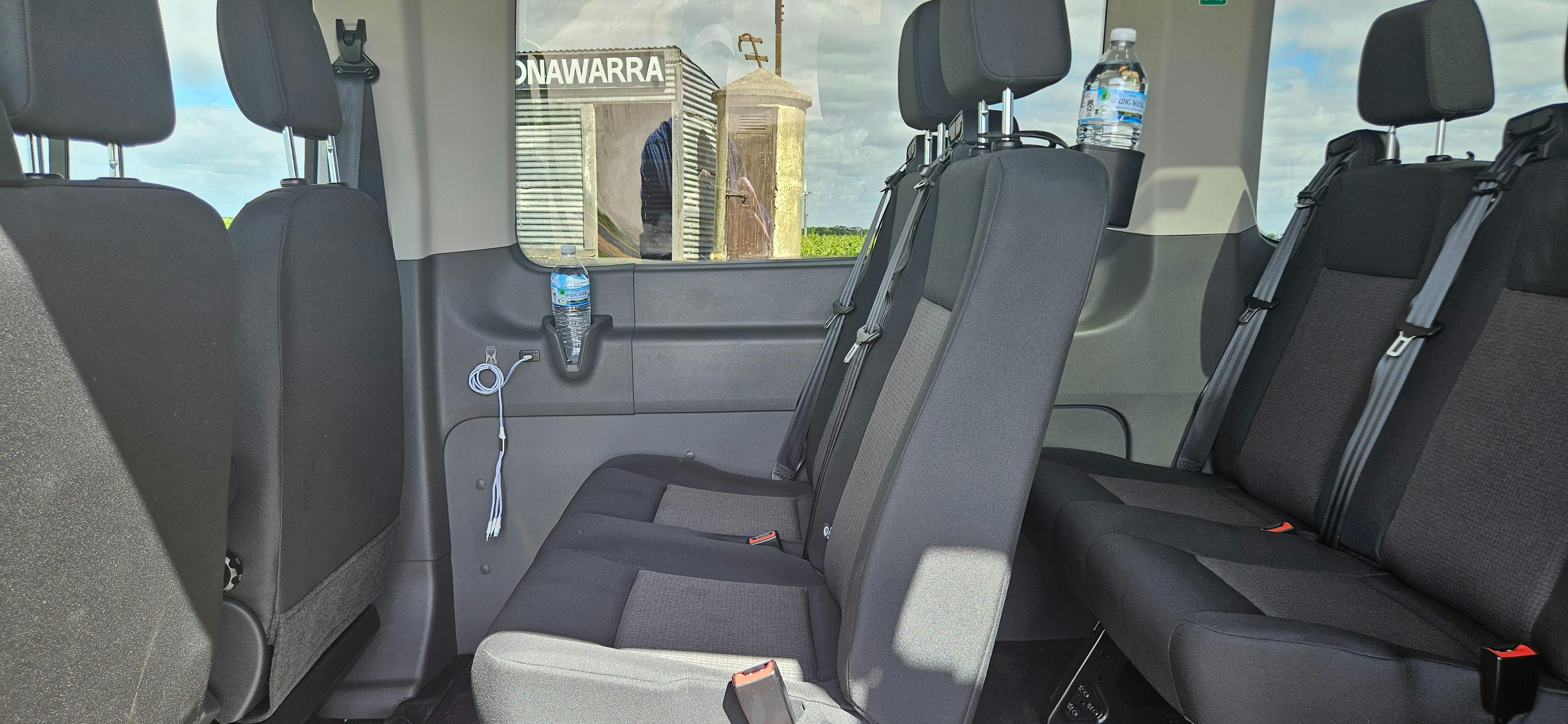 Interior seating and USB charging ports inside Ford Transit touring vehicle for Coonawarra wine tour