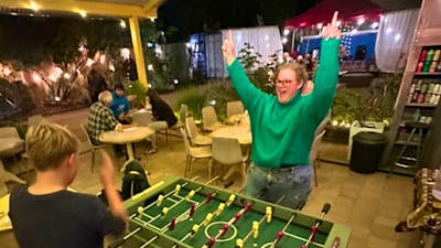 A mother and son playing table foosball