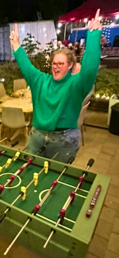A mother and son playing table foosball