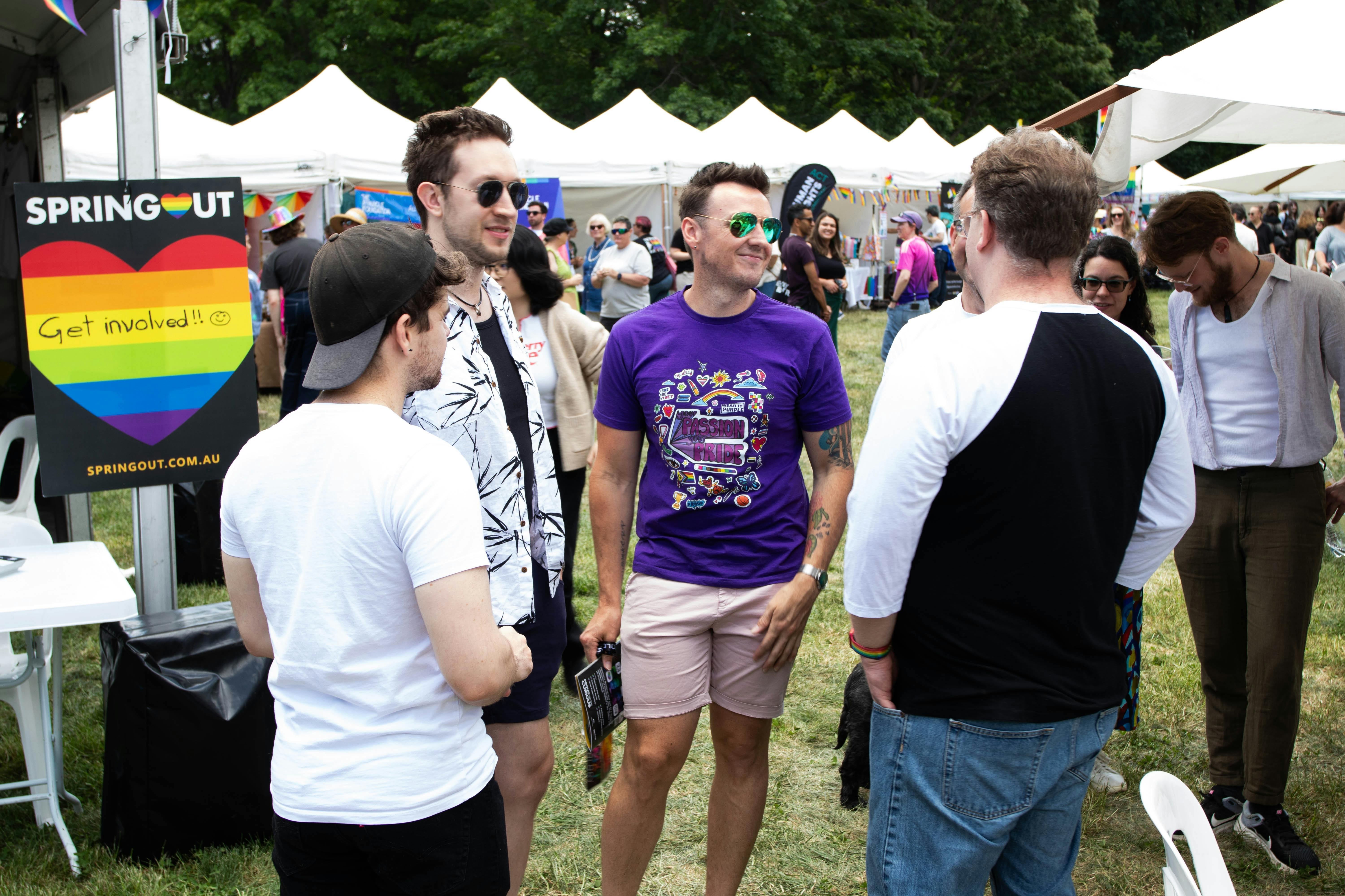Group of friends at Fair Day with Stalls in the background