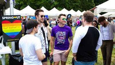 Group of friends at Fair Day with Stalls in the background