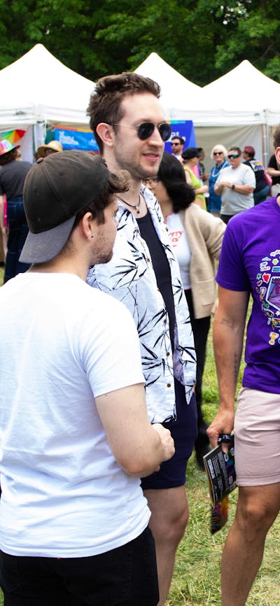 Group of friends at Fair Day with Stalls in the background