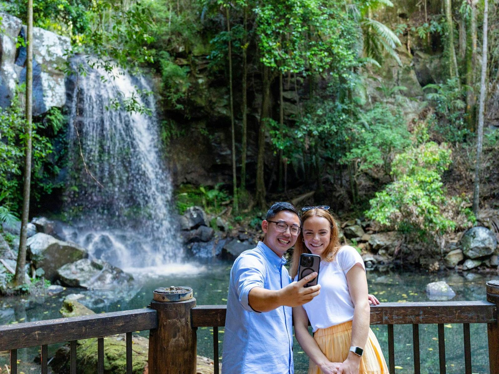 Visitors taking a selfie in front of Cutis Falls Visitors taking a selfie in front of Cutis Falls