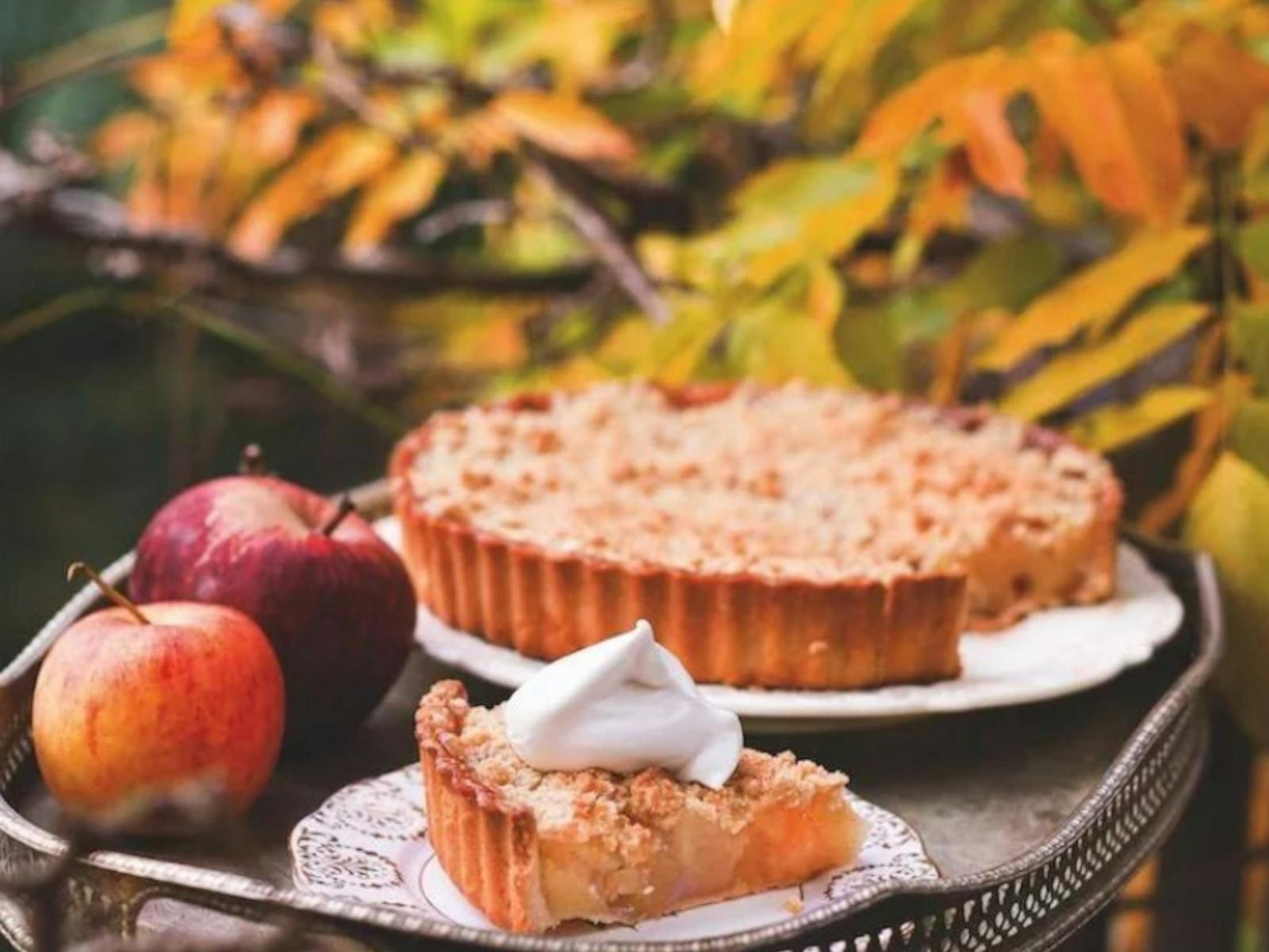 delicious vegan pie next to apples with tree in background