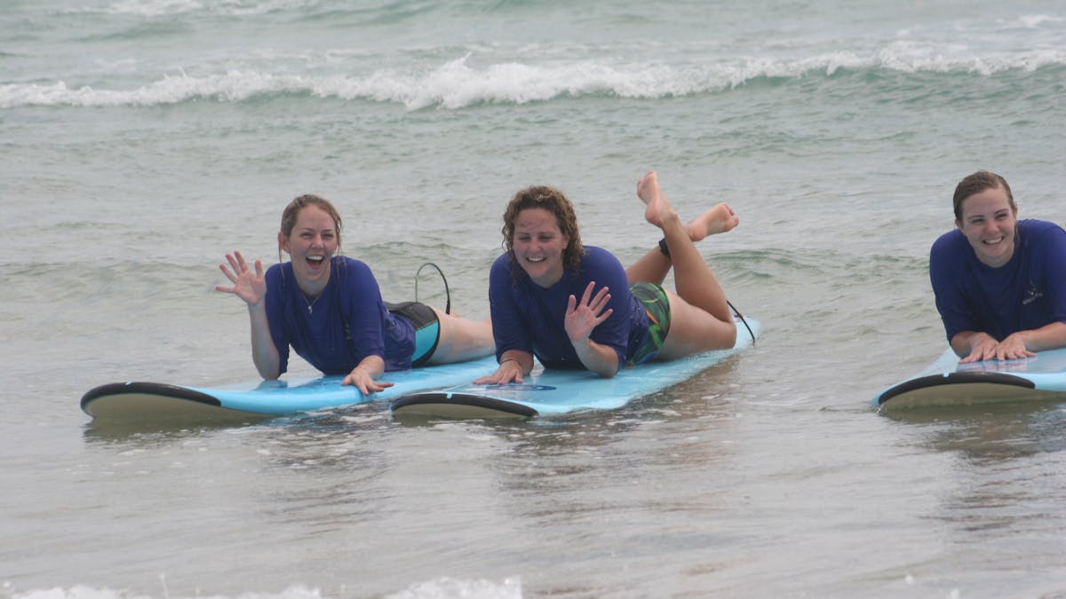 Two smiling surfers from Australian Surfing Adventures