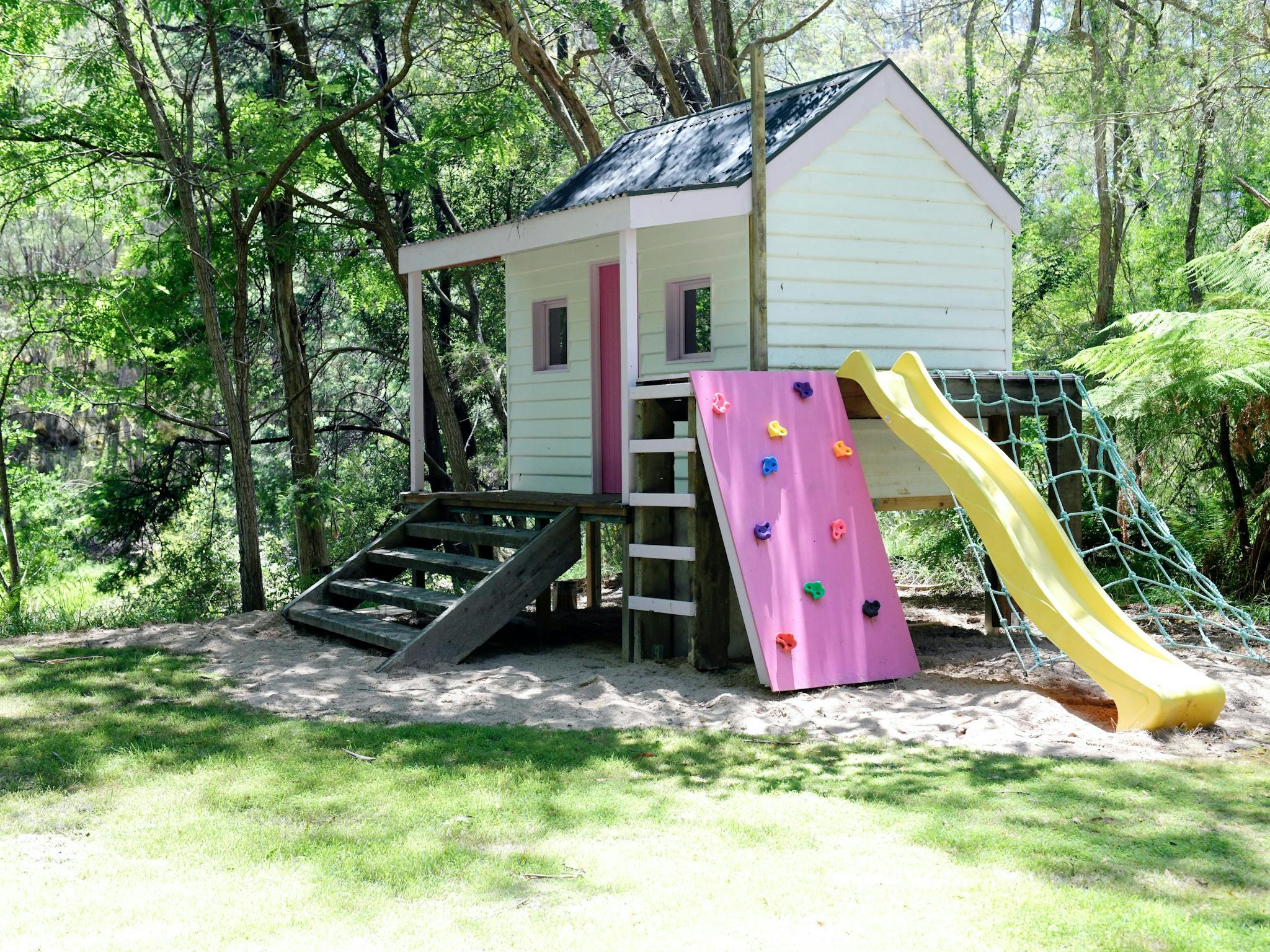 Kids cubby house complete with slides and climbing wall