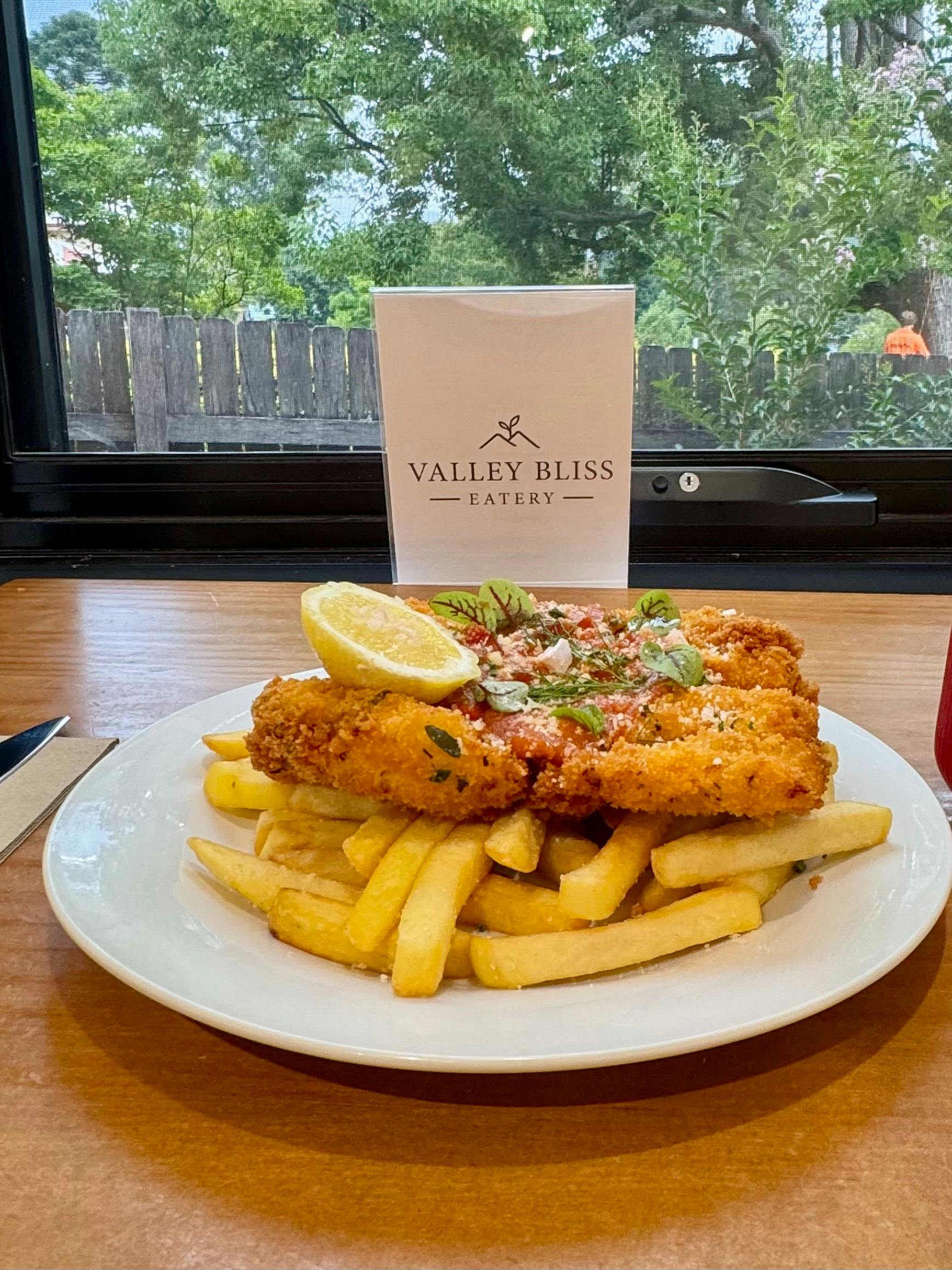 Southern fried chicken burger with chipotle slaw, mango salsa, Swiss cheese on milk bun with fries