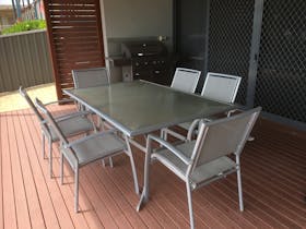 The dining and kitchen area open up conveniently to the deck.