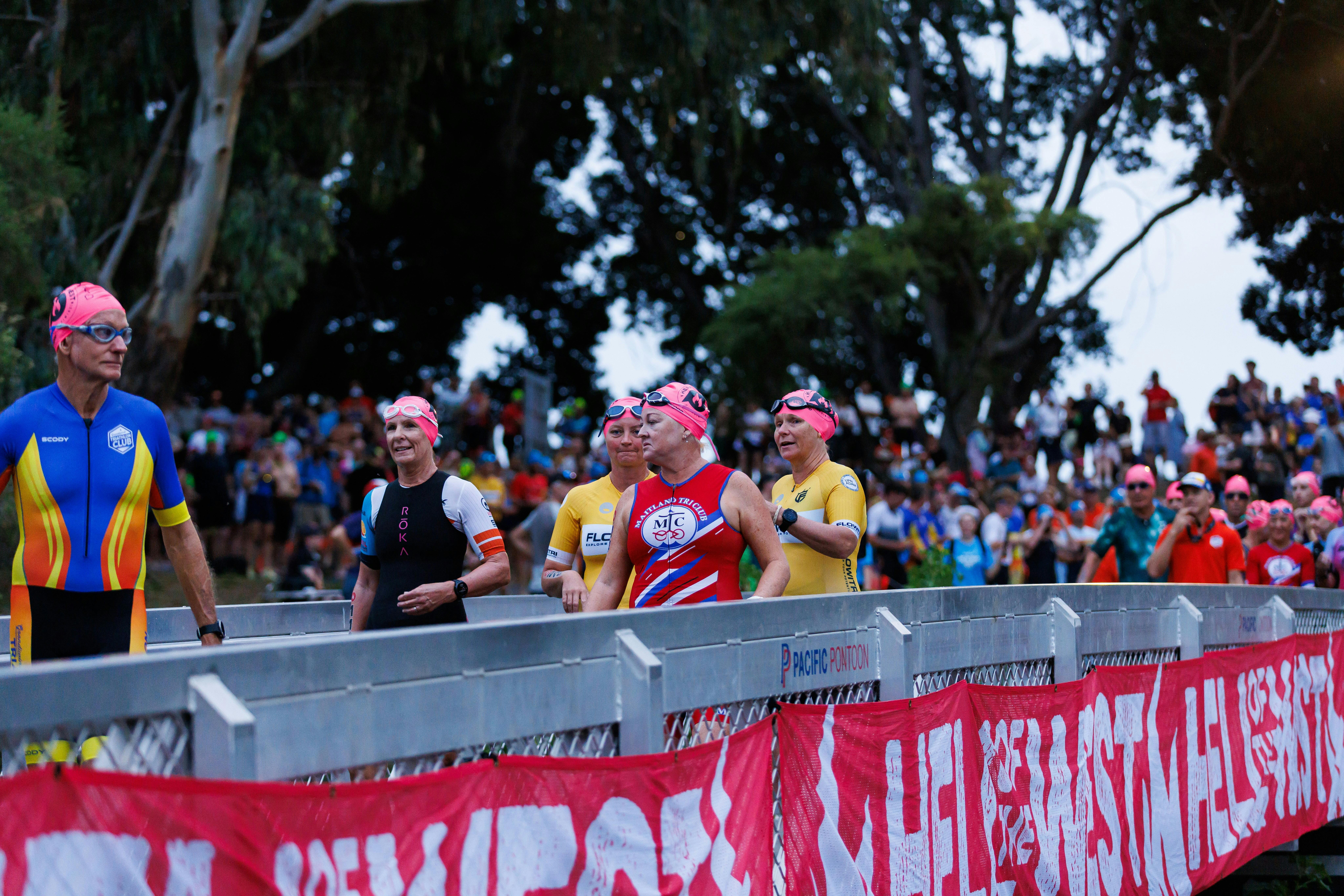 Competitors walking down onto the pontoon for swim start