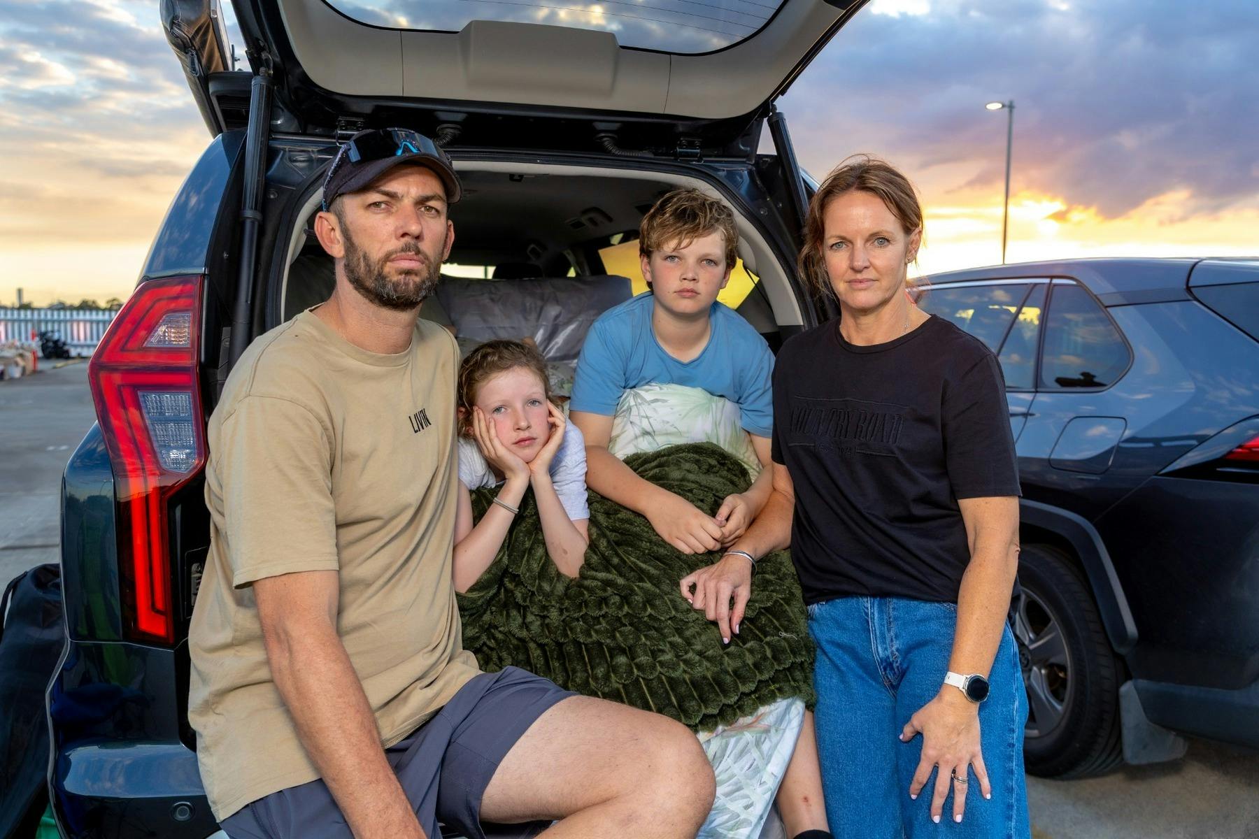 Family of four at the Gold Coast Live Like Her Challenge sitting in the open boot of an SUV