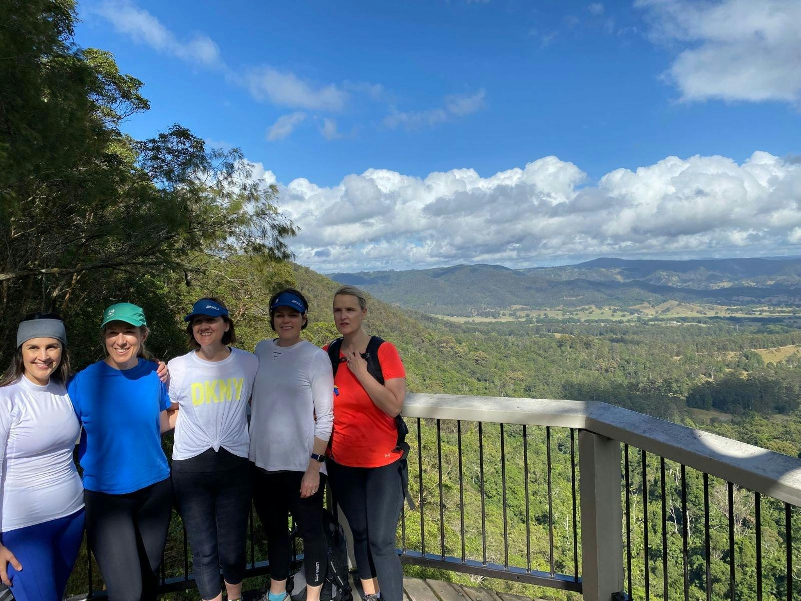 Group smiling and enjoying countryside views on a walk