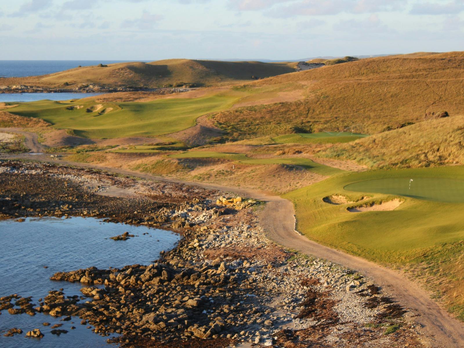 Rugged coastline and fairway winding through the dunes at Ocean Dunes Golf Course