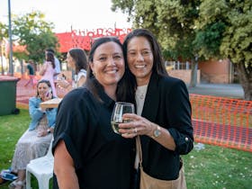 two friends enjoying the sun and wine at the koonara summer fiesta