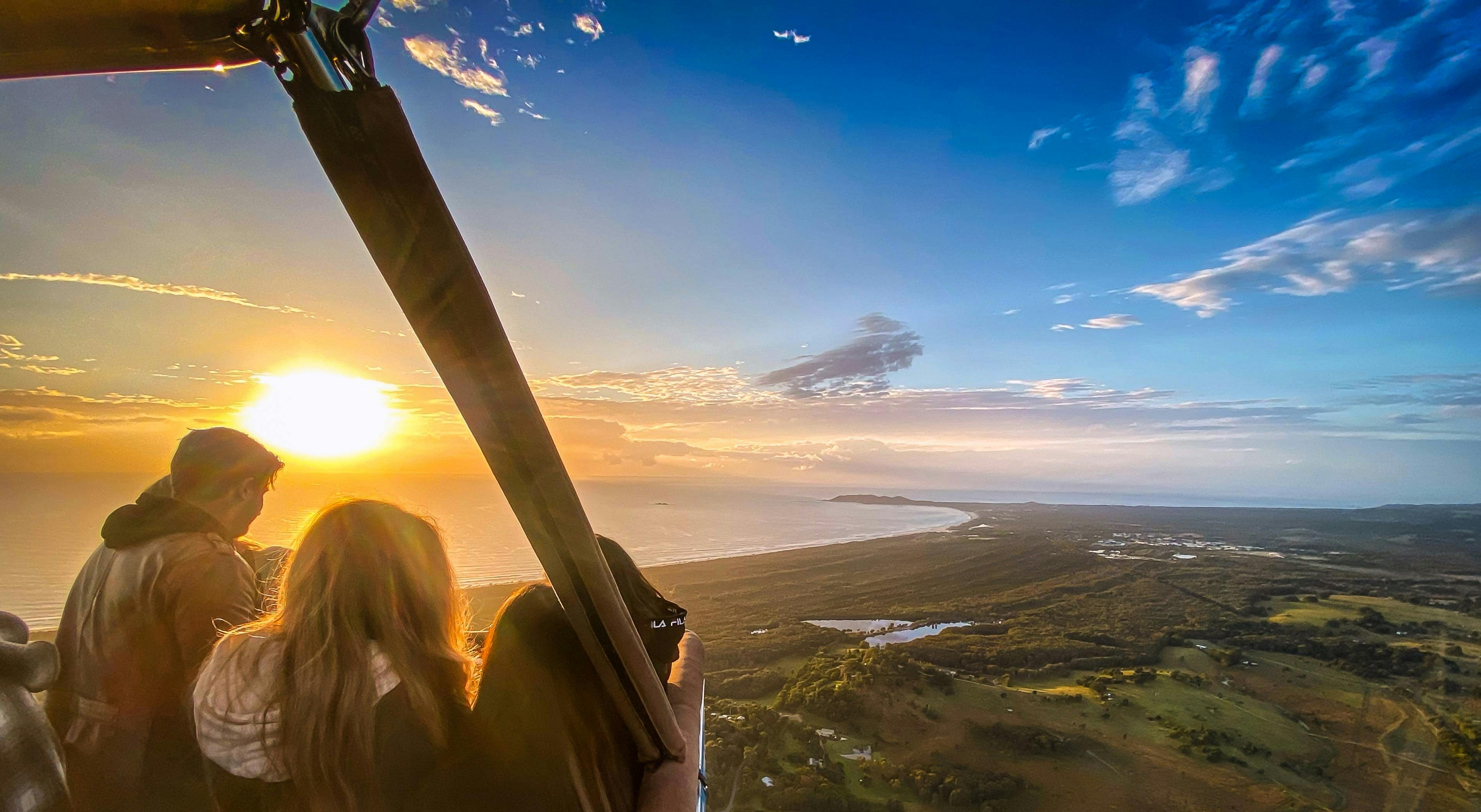 Passengers take in the view from hot air balloon
