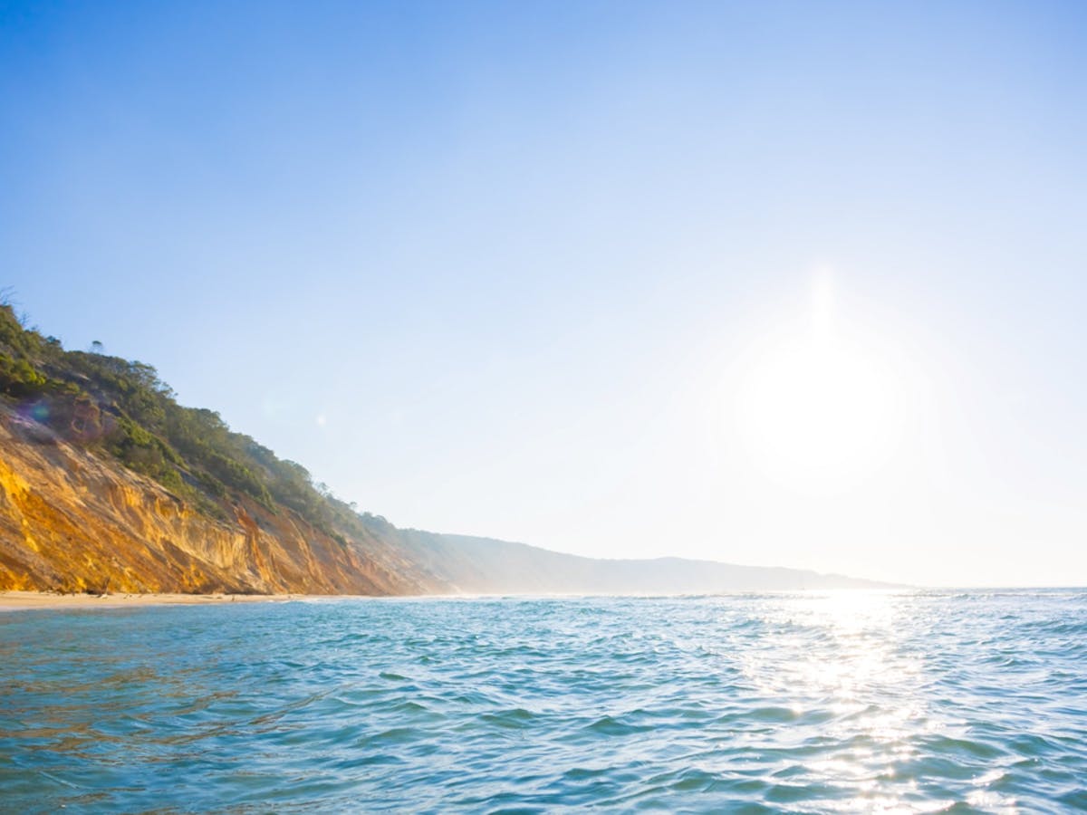 The reflection of the sun on the water with the sandy clips The reflection of the sun on the water with the sandy clips