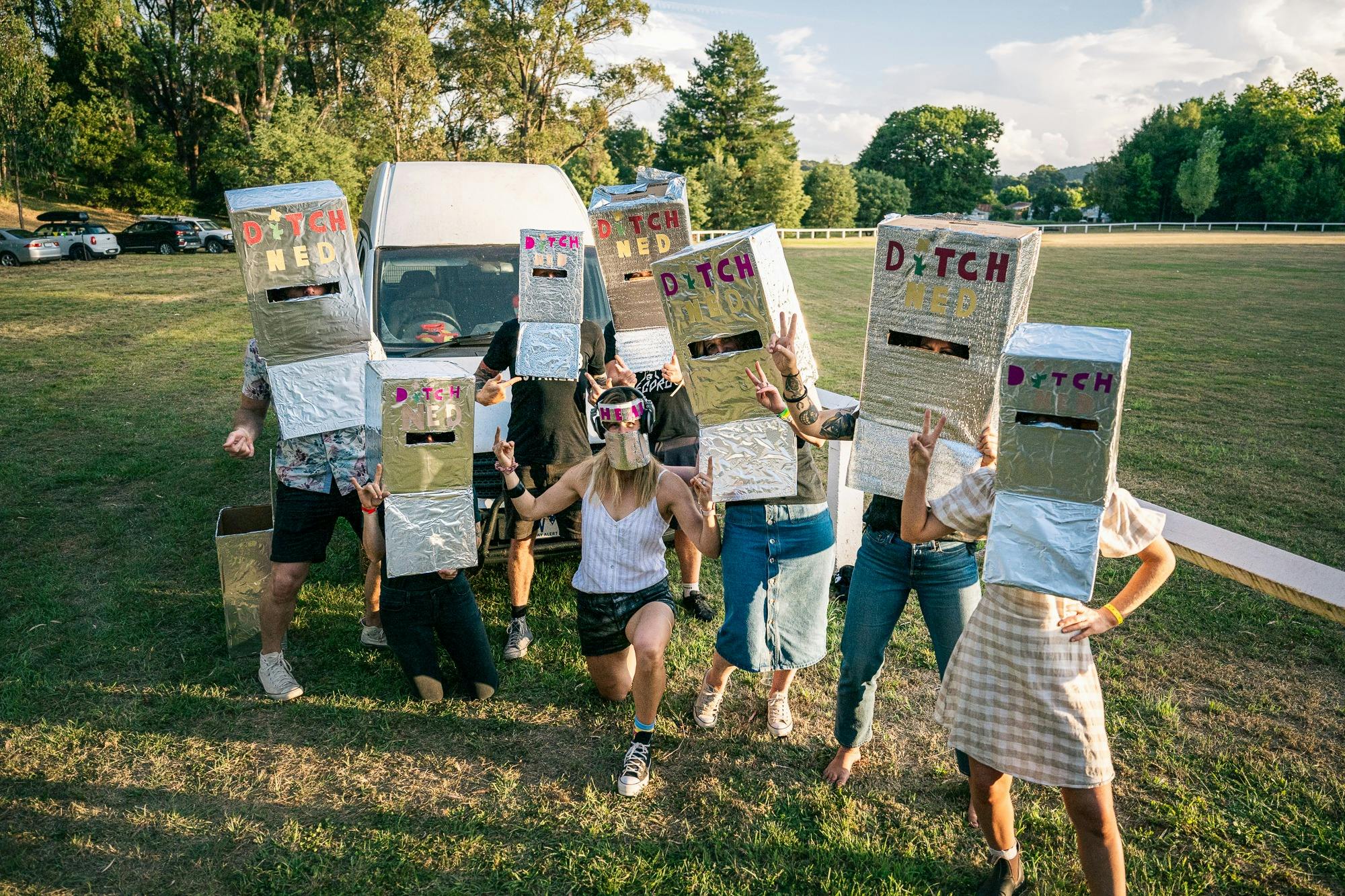 Several people wearing Ned Kelly masks ready to dance to DJ Music