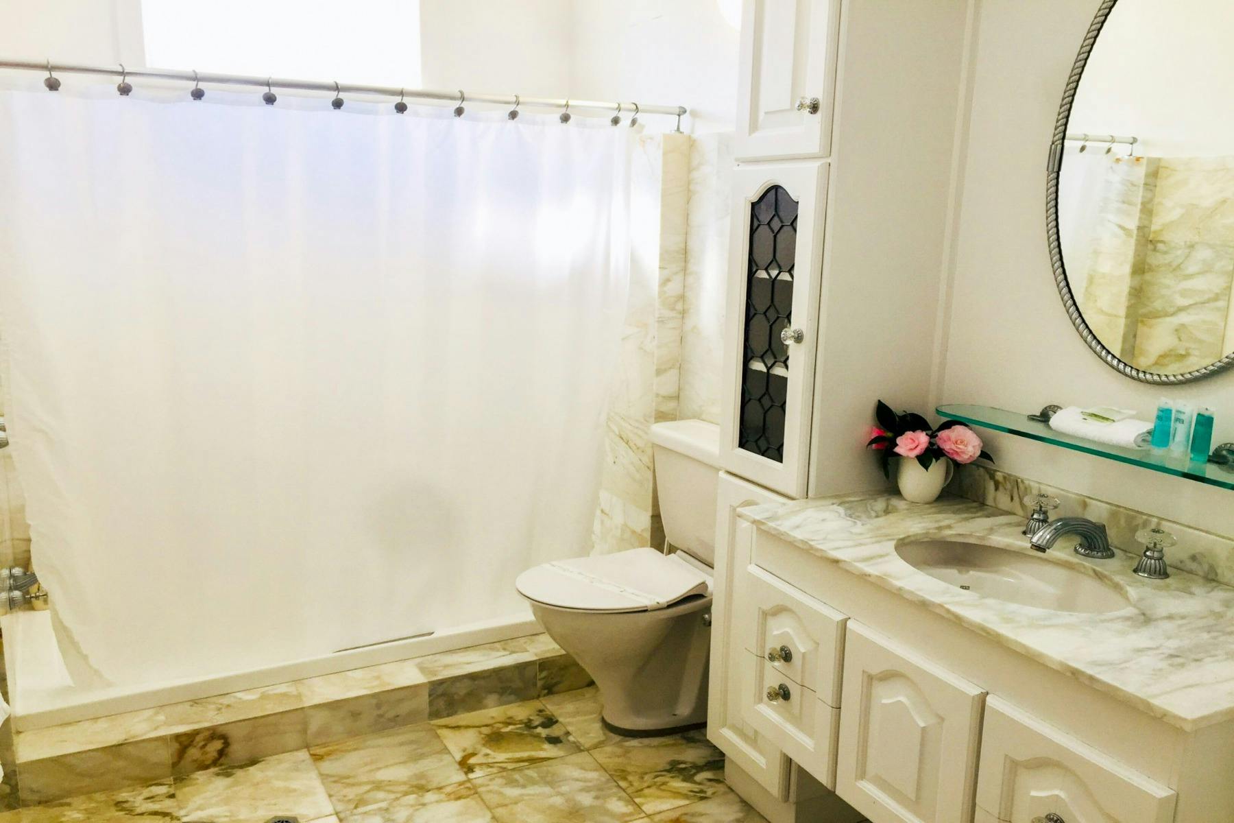 Bathroom with bath over shower and toilet