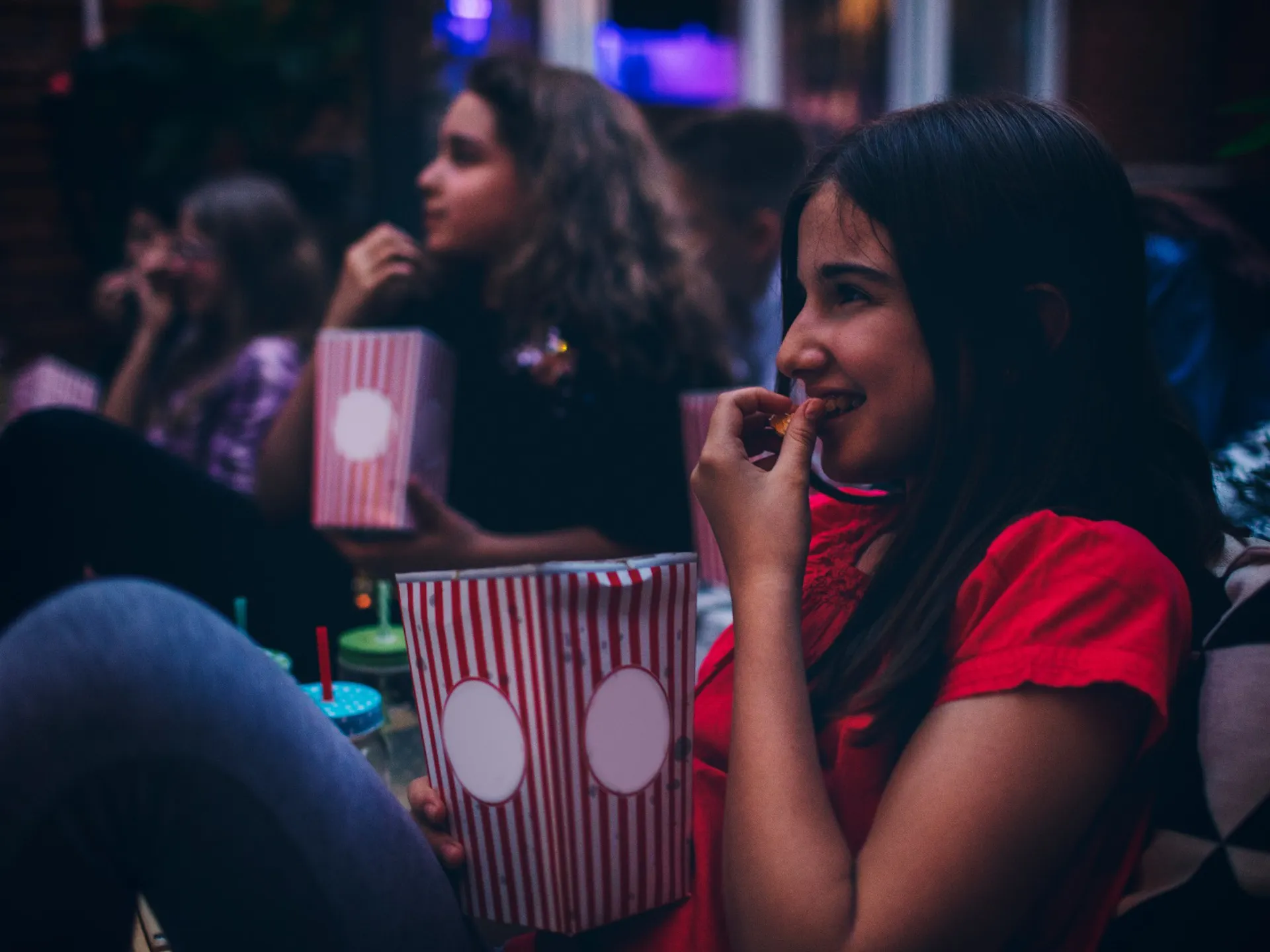 Kids eating popcorn whilst watching a movie