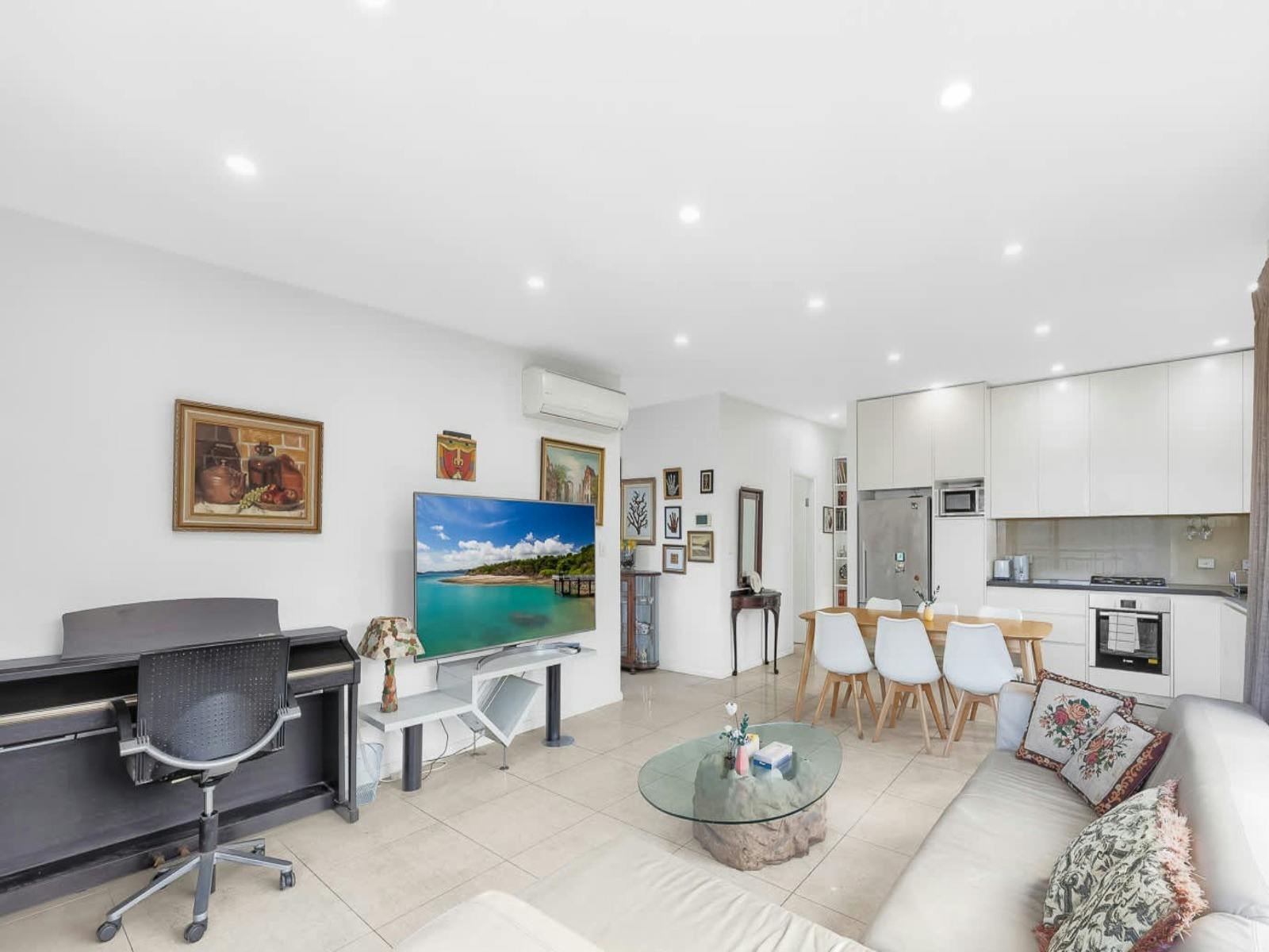 Light-filled living room with comfortable seating, TV, and stylish décor.