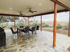 Covered outdoor dining, ceiling fans, gourmet style BBQ, private parking.