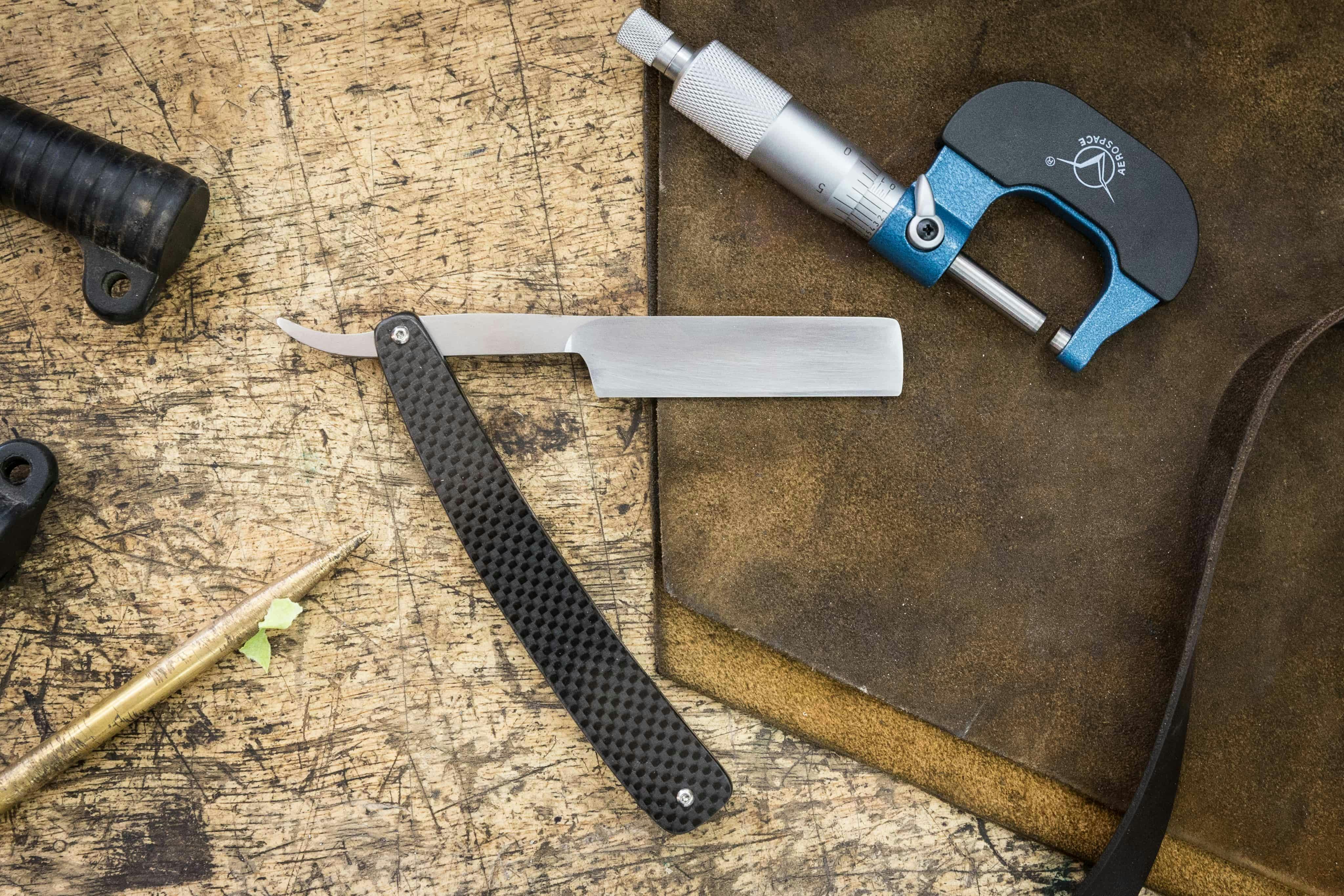 traditional straight razor on a workbench