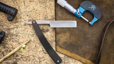 traditional straight razor on a workbench