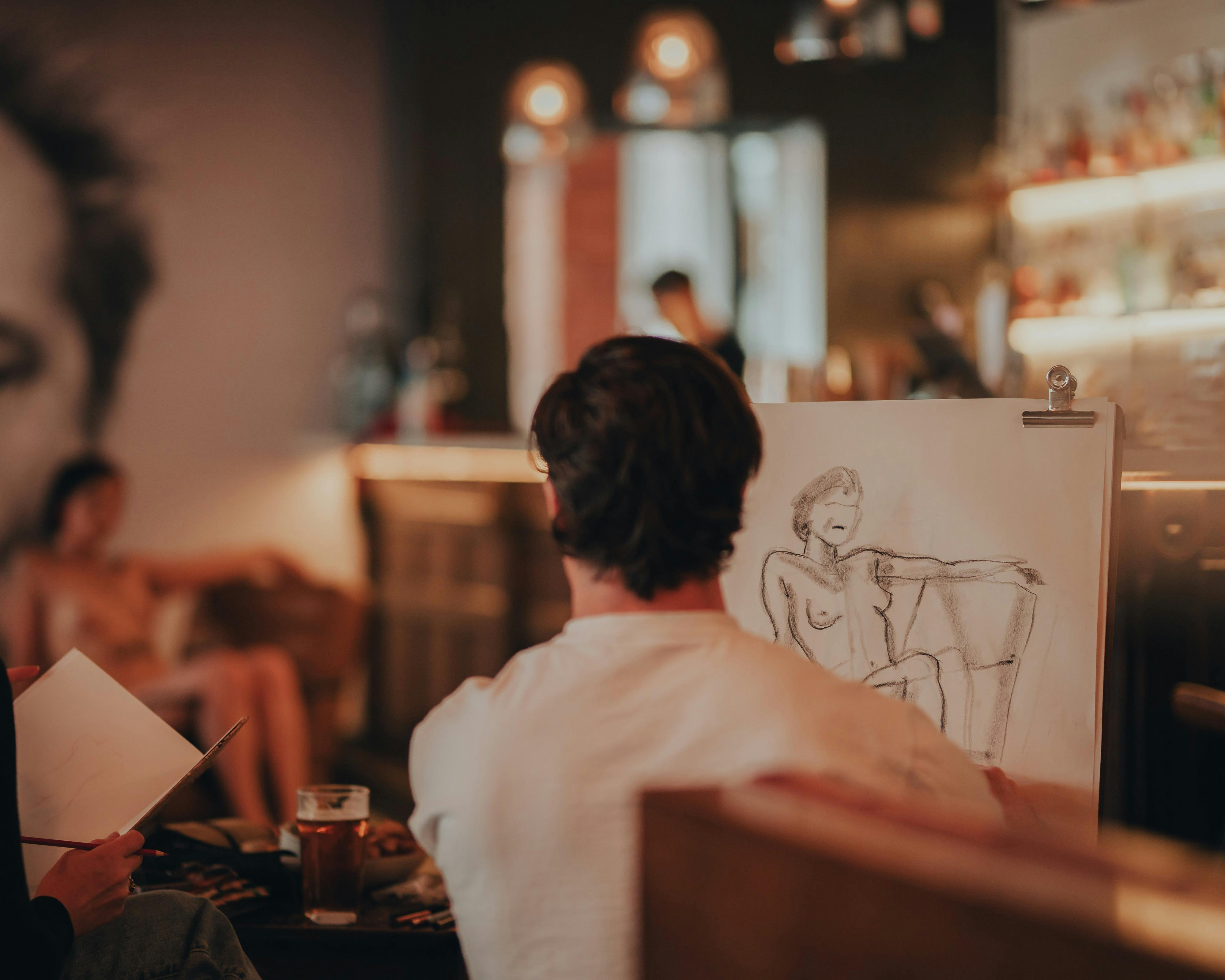 Person drawing model sitting on chair