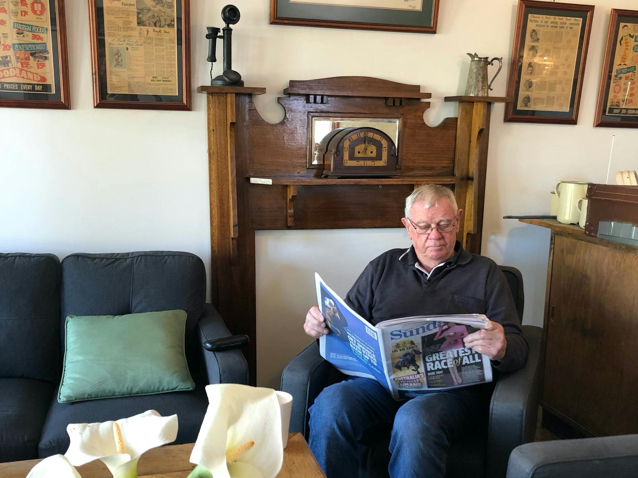 Man reading a newspaper on an easy chair.