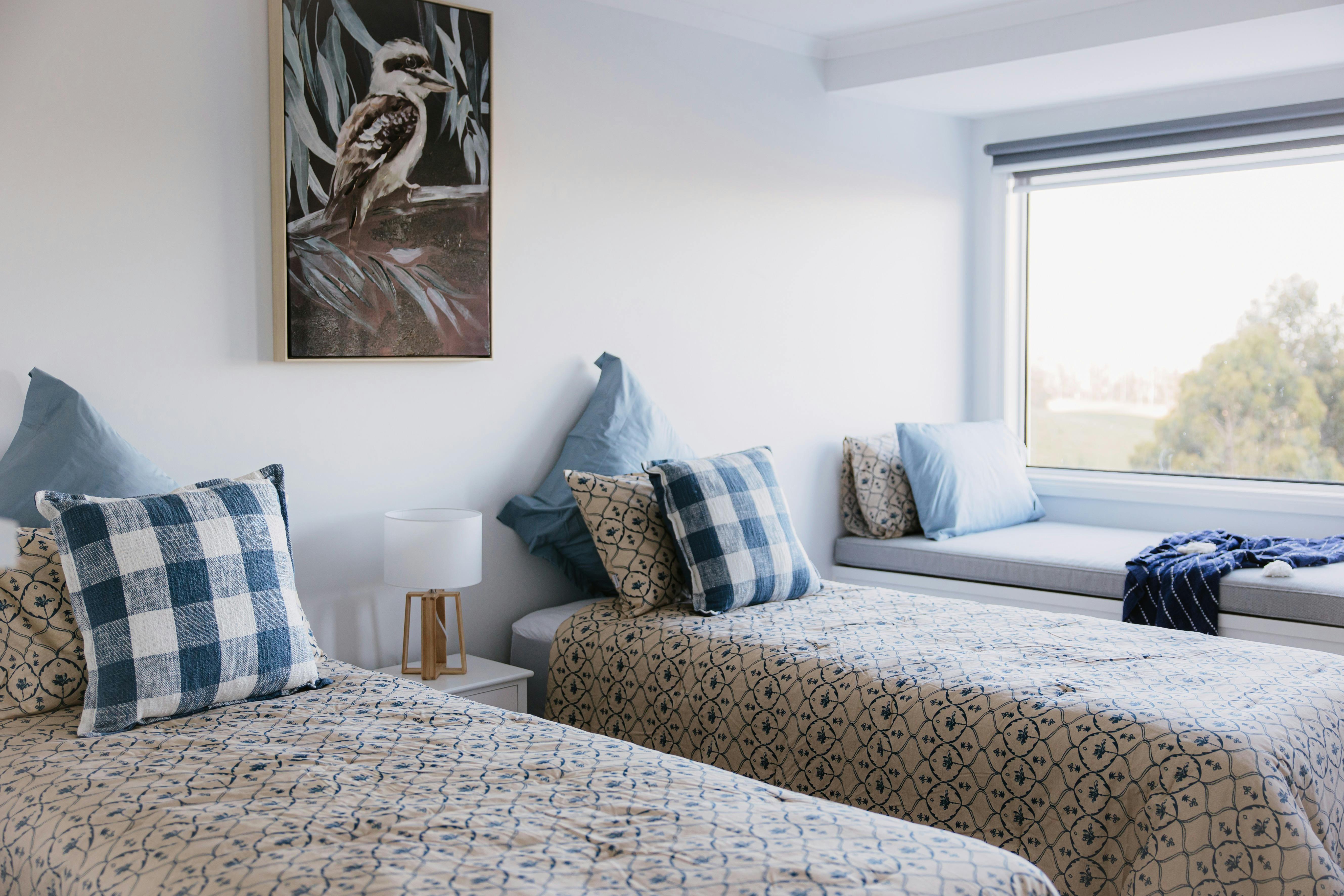 Two beds with a large window, bench seat and relaxing countryside views.