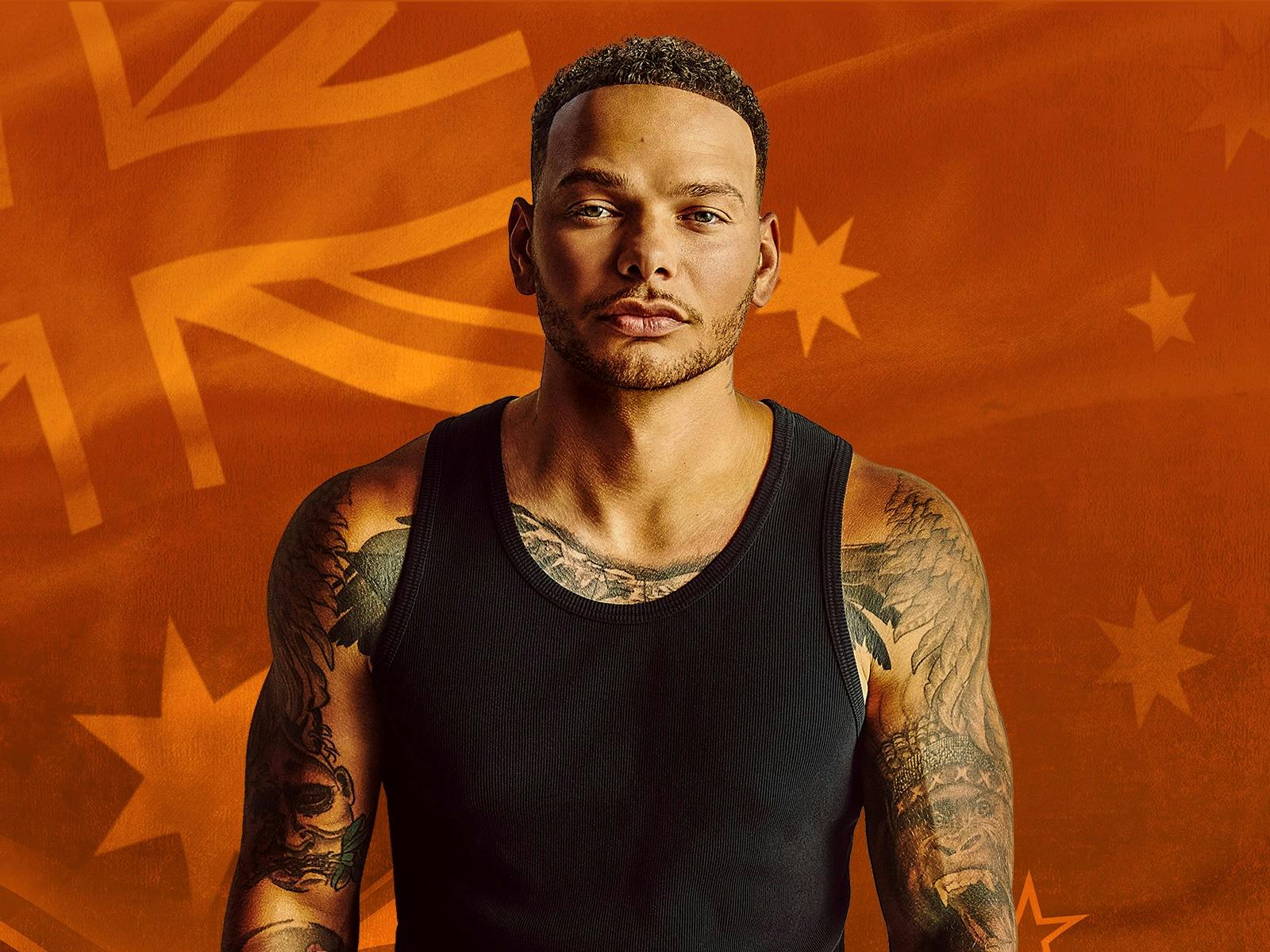 Kane Brown standing in front of Australian Flag