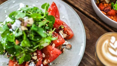 Plate showing colourful meal and coffee cup