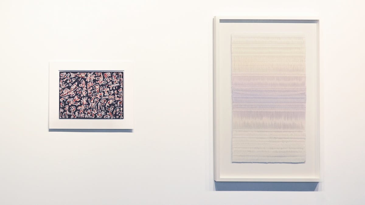 Two artworks displayed on the gallery wall