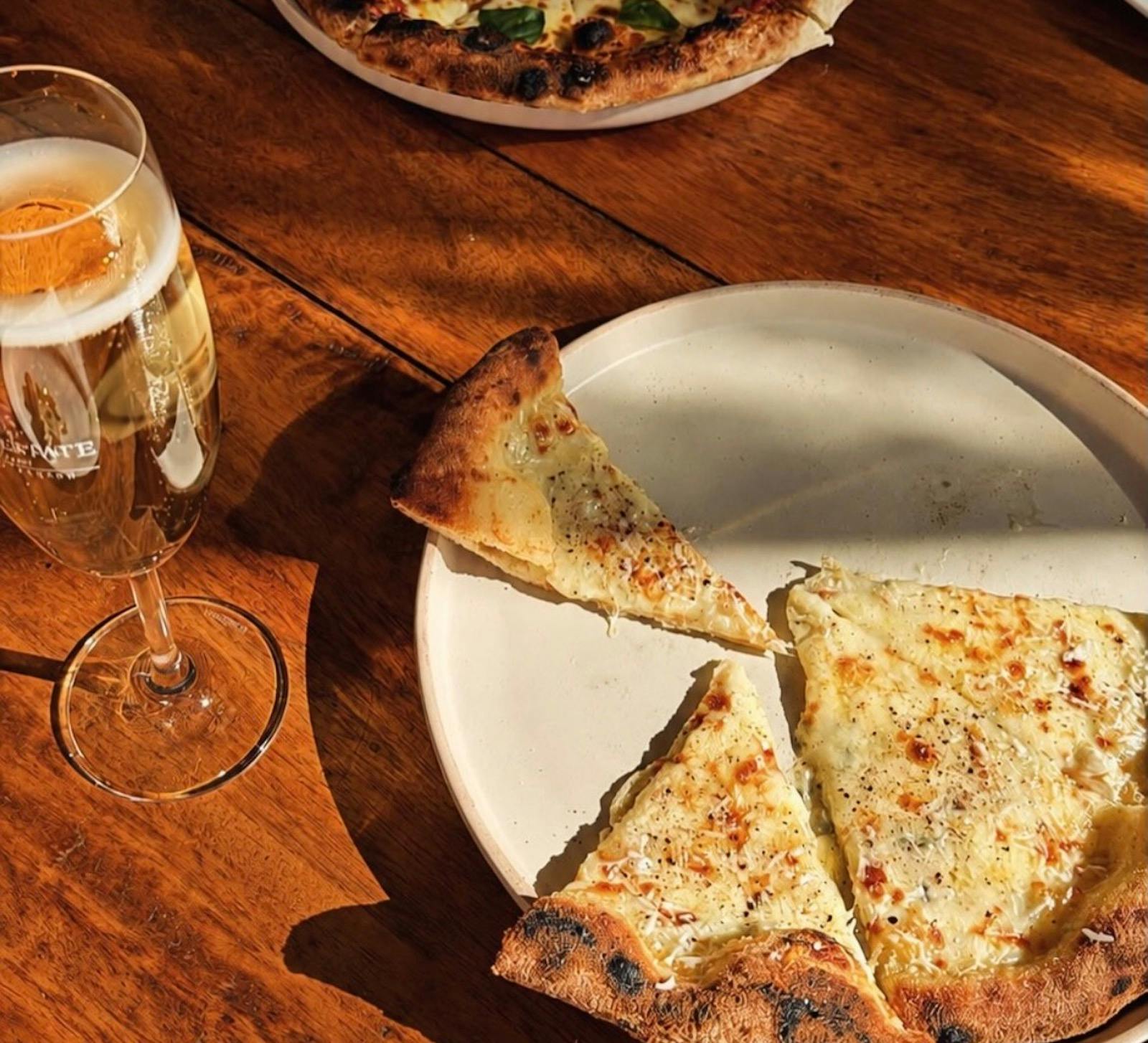 Grove Estate wood fired pizza and a glass of champagne