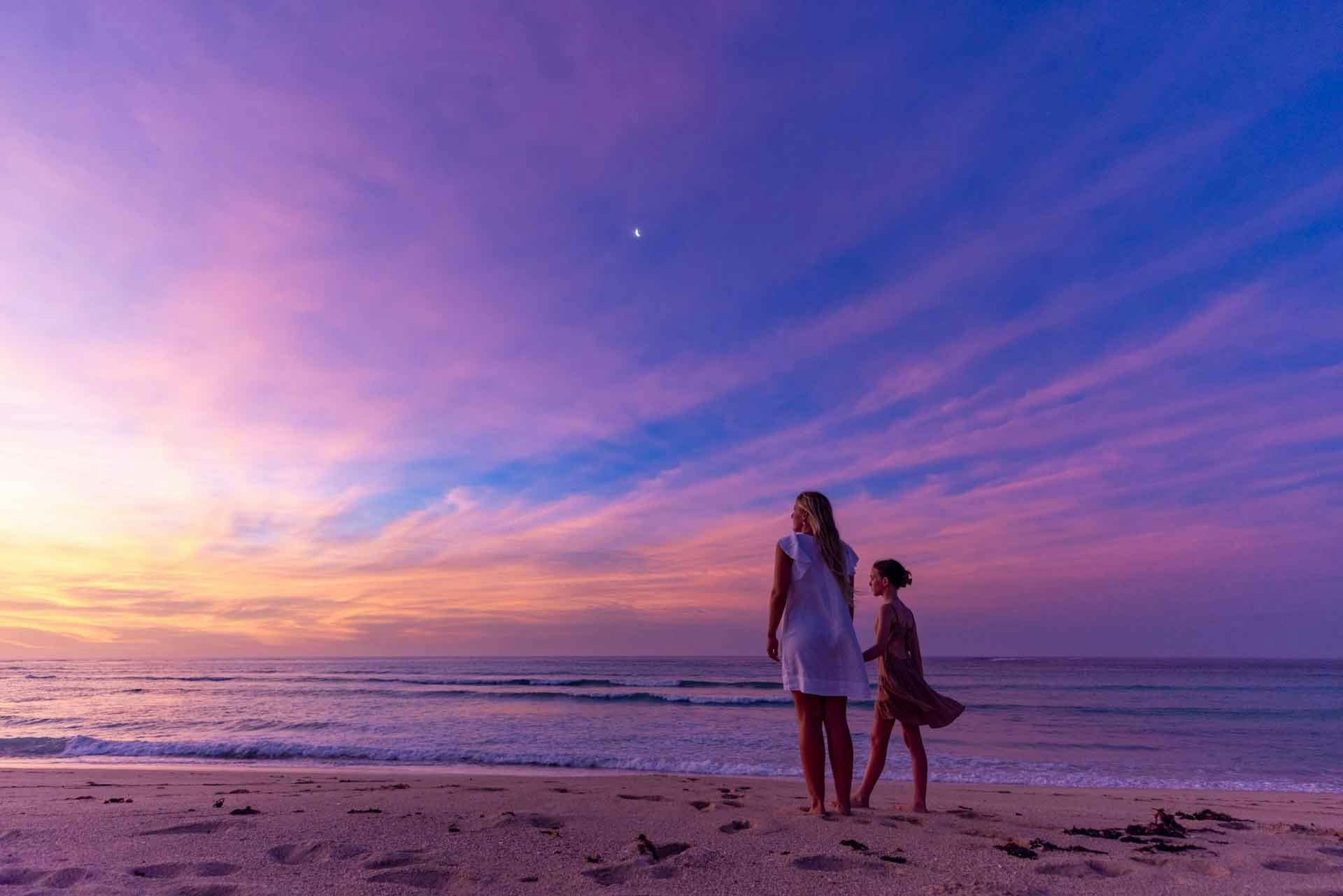 young family walking into the sunset in Exmouth at Ningaloo Reef