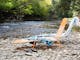 Sun loungers on a pebble beach by the river