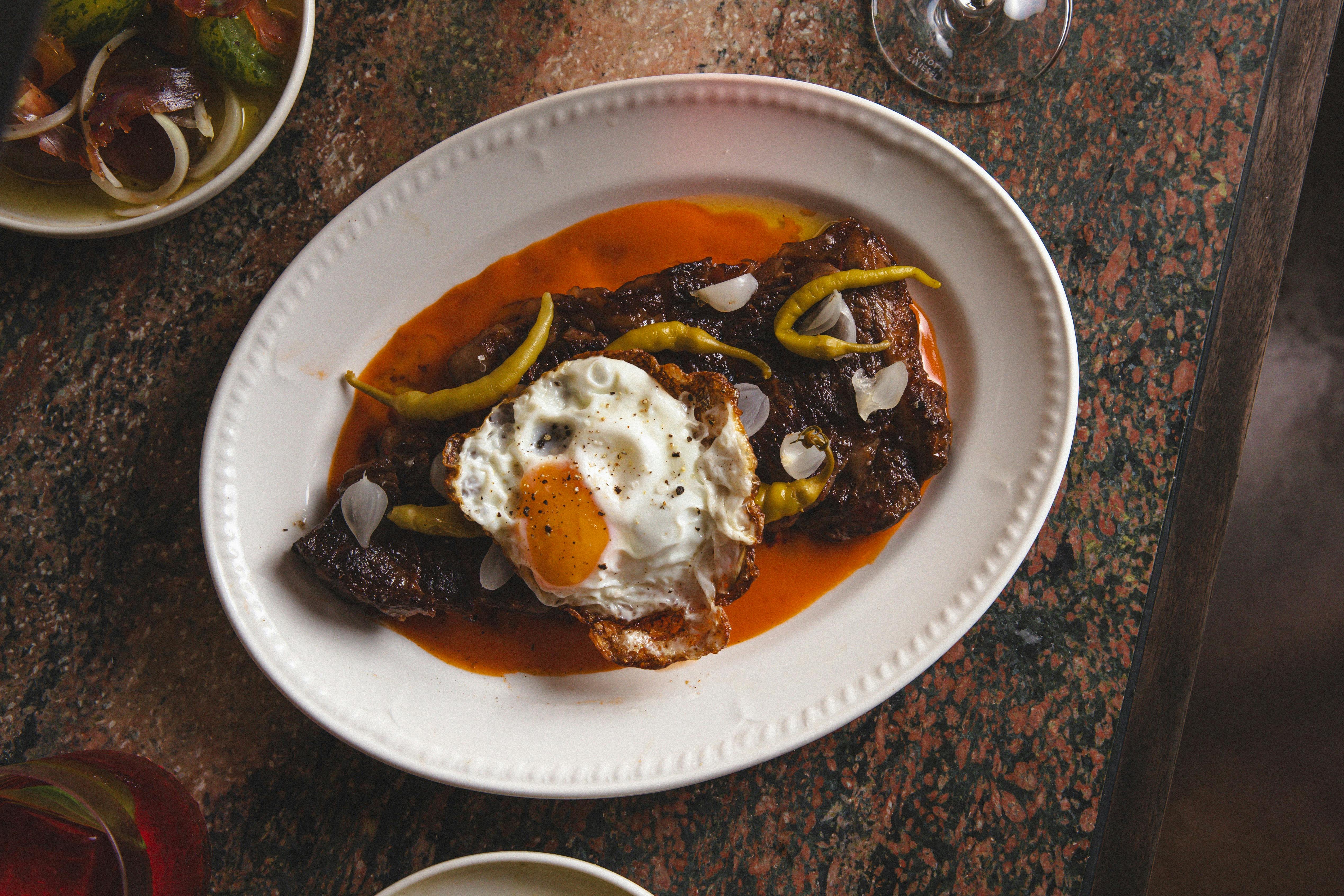 Ranger's Valley steak with guindillas, tomato butter and a crispy fried egg.