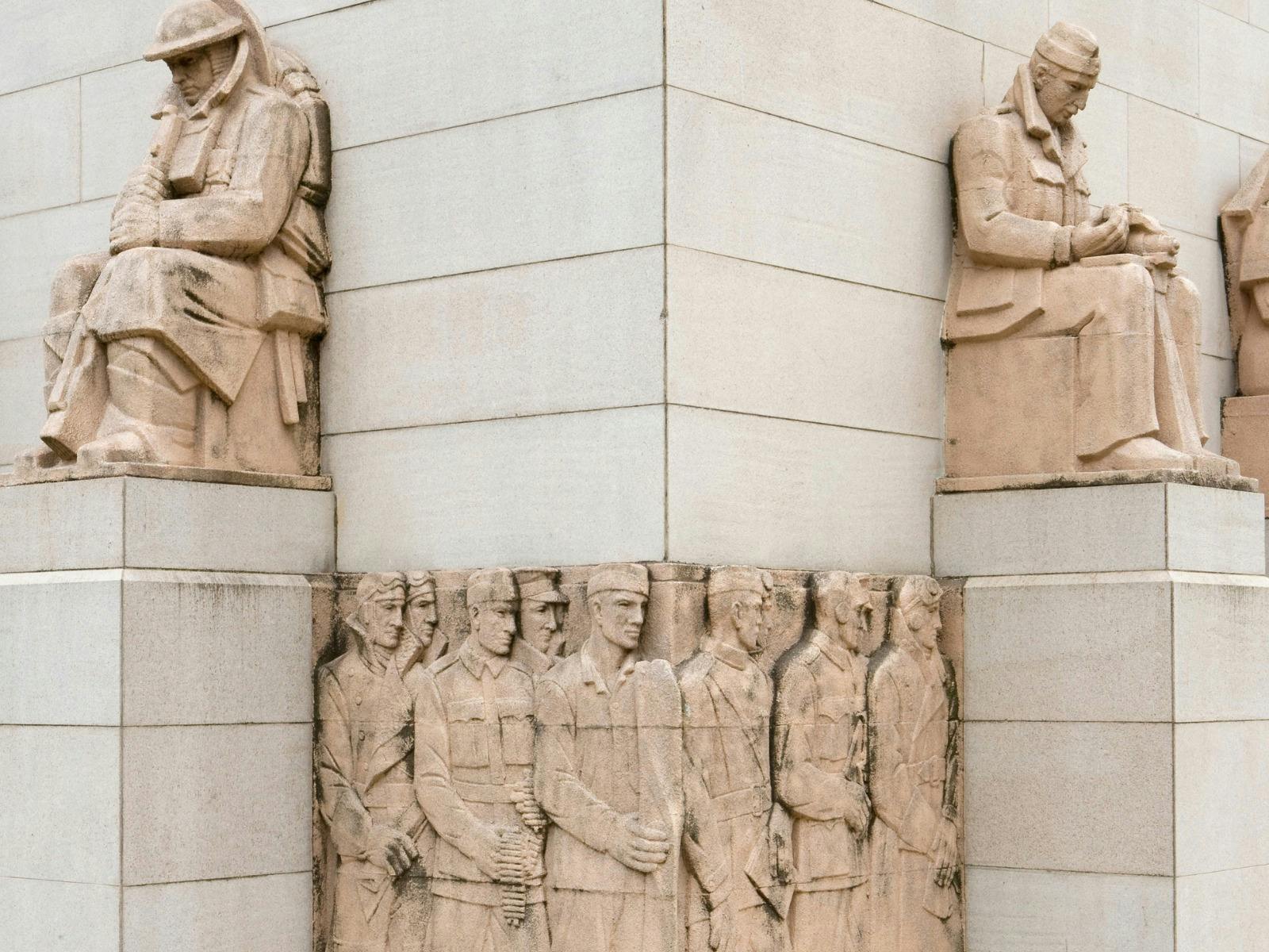 Anzac Memorial sculptures and military relief carvings on the sandstone exterior façade.