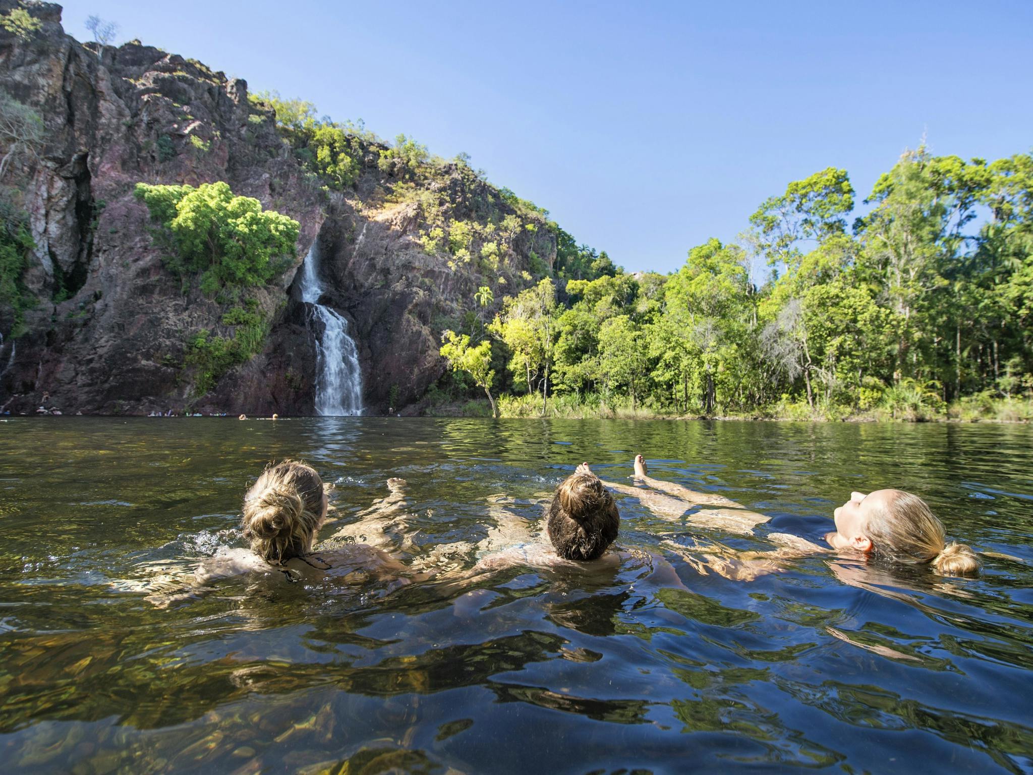 Three visitors enjoying Wangi Falls, Litchfield National Park