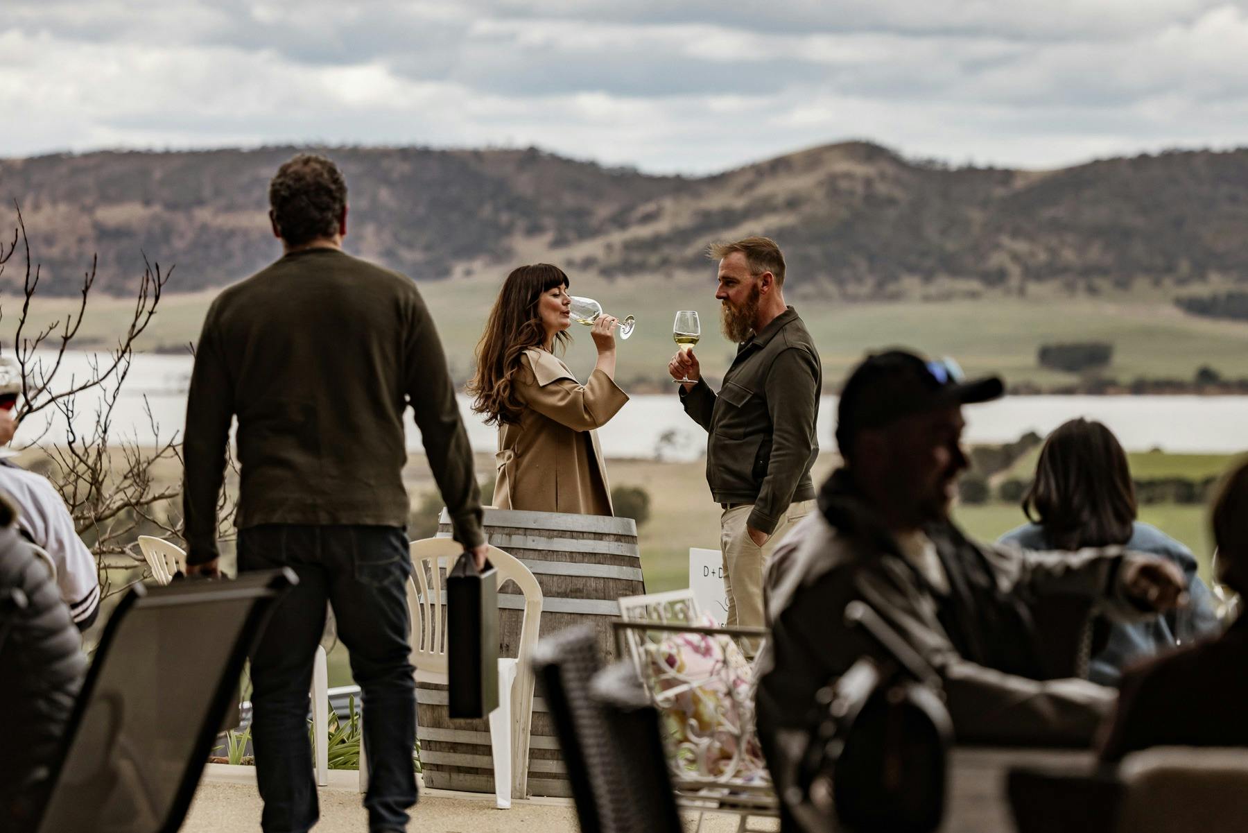 couple drinking wine with Coal River Valley in the background